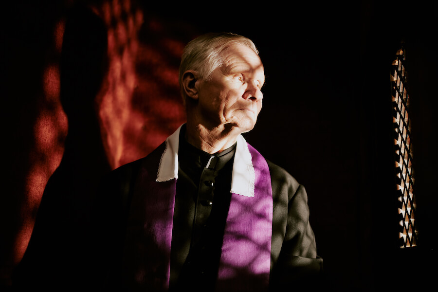 Ksiądz w konfesjonale podczas spowiedzi Ksiądz w konfesjonale podczas spowiedzi